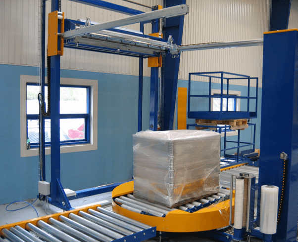 Conveyorized pallet wrapping line with top film sheet dispenser